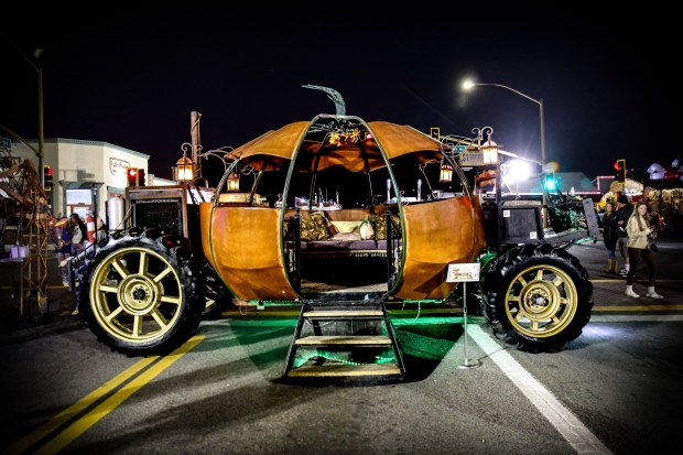 Ramona resident Wylie Weldy welcomed guests at the Christmas Tree Lighting event to sit in the pumpkin-shaped, steampunk-style carriage he made with his wife, Dawn Sardinas. The couple's carriage rental business is called The Punkin Project. (Stephanie Ogilvie)