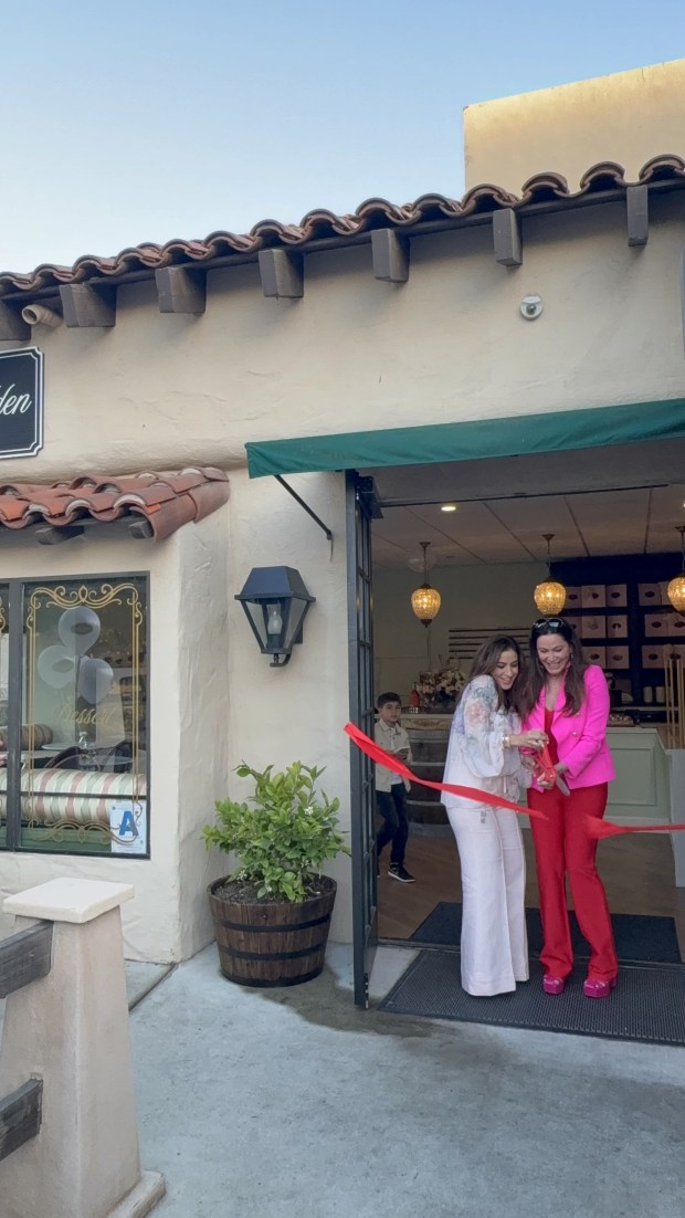 Sandy Rahib and Tina Assi snip the ribbon on the new Little Hidden Bakery. (Courtesy Sandy Rahib)
