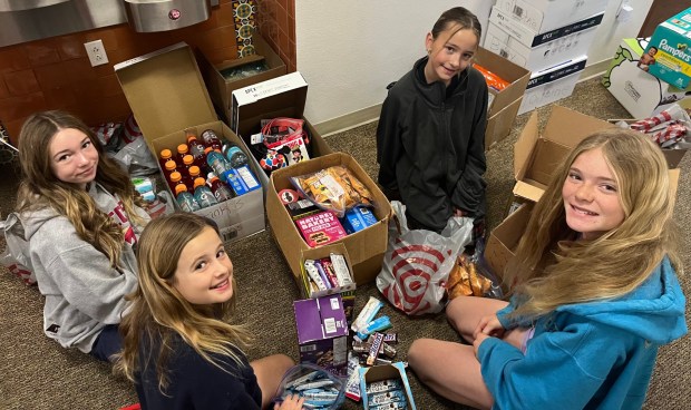 R. Roger Rowe fifth graders Amelia Rose James, Blake Helms, Savannah Jass and Parker Rose Gleeson helped sort donations for L.A. Strong. (Karen Billing)