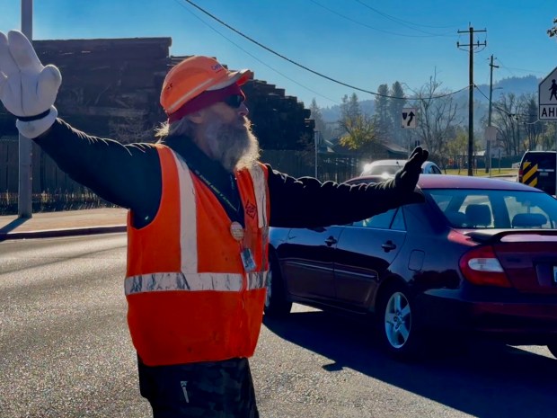 Community members like Geronimo take their jobs seriously. With traffic backed up on a side street for over a quarter of a mile, it takes dedication and commitment to make sure the public is efficiently and safely provided with food. (Carole Brodsky  Fort Bragg Advocate-News)