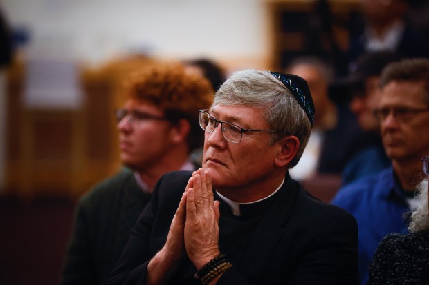 Father Jon Pedigo, a Catholic priest in the South Bay, sits in solidarity with the Jewish community and listens to people speak out against hate after students at Branham High School arranged themselves into the shape of a swastika on the school's football field a few weeks ago, at Congregation Shir Hadash in Los Gatos, Calif., on Saturday, Dec. 20, 2025. (Shae Hammond/Bay Area News Group)