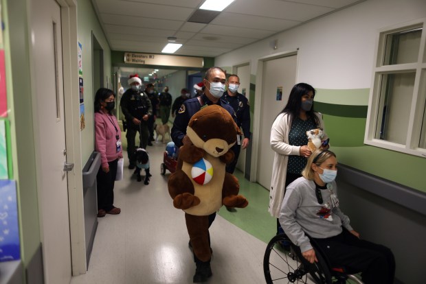 Members of the Santa Clara County Fire Department and Santa Clara County Sheriff's Department deliver Christmas toys in children's wing of the Santa Clara Valley Medical Center on Wednesday, Dec. 17, 2025, in San Jose, Calif. The two departments collected hundreds of toys from the community to be distributed at the hospital and other sites throughout the county. (Aric Crabb/Bay Area News Group)
