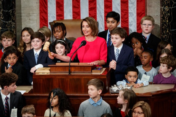 House Speaker Nancy Pelosi, D-San Francisco, surrounded by her grandchildren and other children, pounds the gavel at the Capitol in Washington DC, Thursday, Jan. 3, 2019. (AP Photo/Carolyn Kaster)