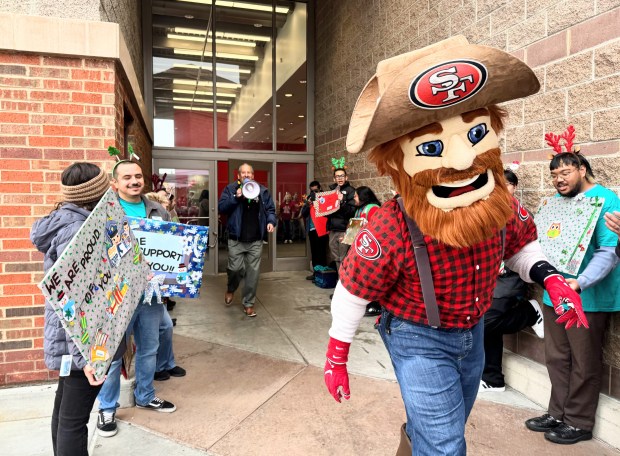 Shop With a Cop Silicon Valley Foundation Executive Director Darrell Cortez follows 49ers mascot Sourdough Sam outside the Target store on Coleman Avenue in San Jose during the Heroes and Helpers shopping spree on Wednesday, Dec. 10, 2025. (Sal Pizarro/Bay Area News Group)