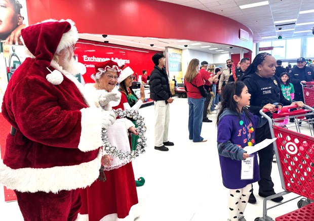 Santa Claus and Mrs. Claus greet student shoppers and their law enforcement companions at the Target store on Coleman Avenue in San Jose during Shop With a Cop Silicon Valley Foundation's Heroes and Helpers shopping spree on Wednesday, Dec. 10, 2025. (Sal Pizarro/Bay Area News Group)