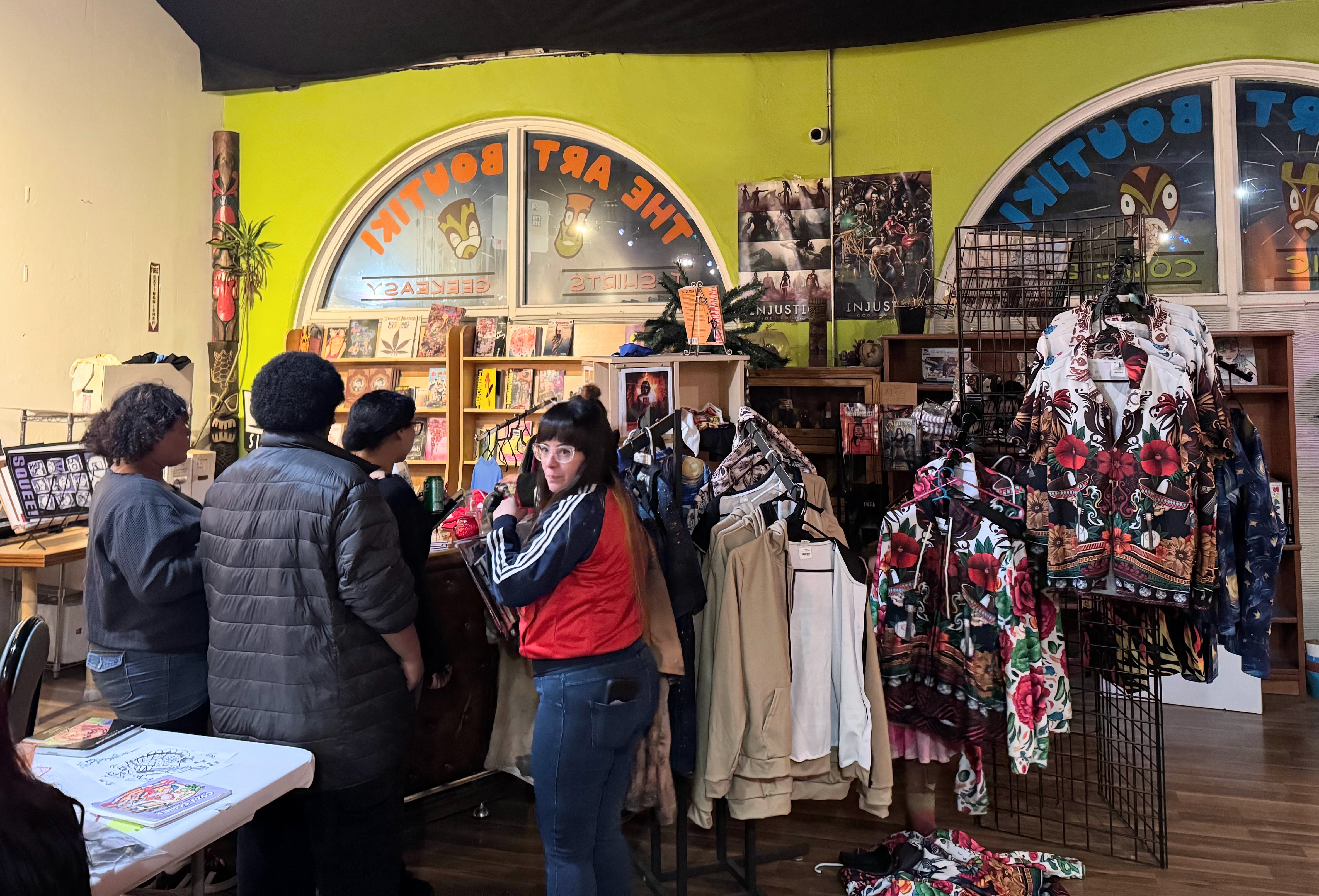 Customers look through clothing items for sale at the Art...