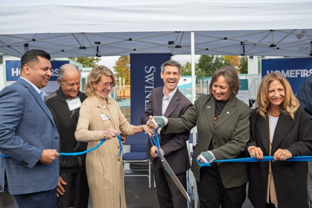From left to right, HomeFirst CEO Rene Ramirez, philanthropist John Sobrato, DignityMoves CEO Elizabeth Funk, San Jose Mayor Matt Mahan, Vice Mayor Pam Foley and City Manager Jennifer Maguire cut the ceremonial ribbon on Nov. 17, 2025, to mark the opening of a new tiny home community at 5205 Cherry Ave. (Devan Patel/Bay Area News Group)