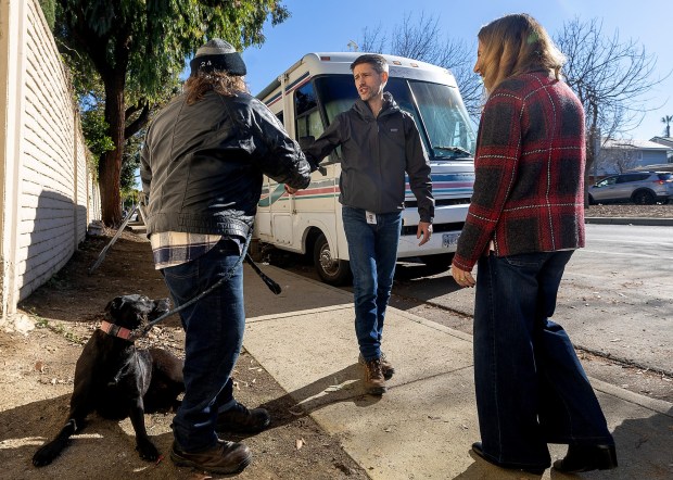 San Jose Mayor Matt Mahan speaks with Paul Peterson who is among the dozens of people camping in RVs along Chynoweth Avenue, Thursday, Jan. 9, 2025. The city is beginning enforcement of a program impacting RVs and lived-in vehicles with tow away zones at 30 locations throughout the city including one near Chynoweth Park, . (Karl Mondon/Bay Area News Group)