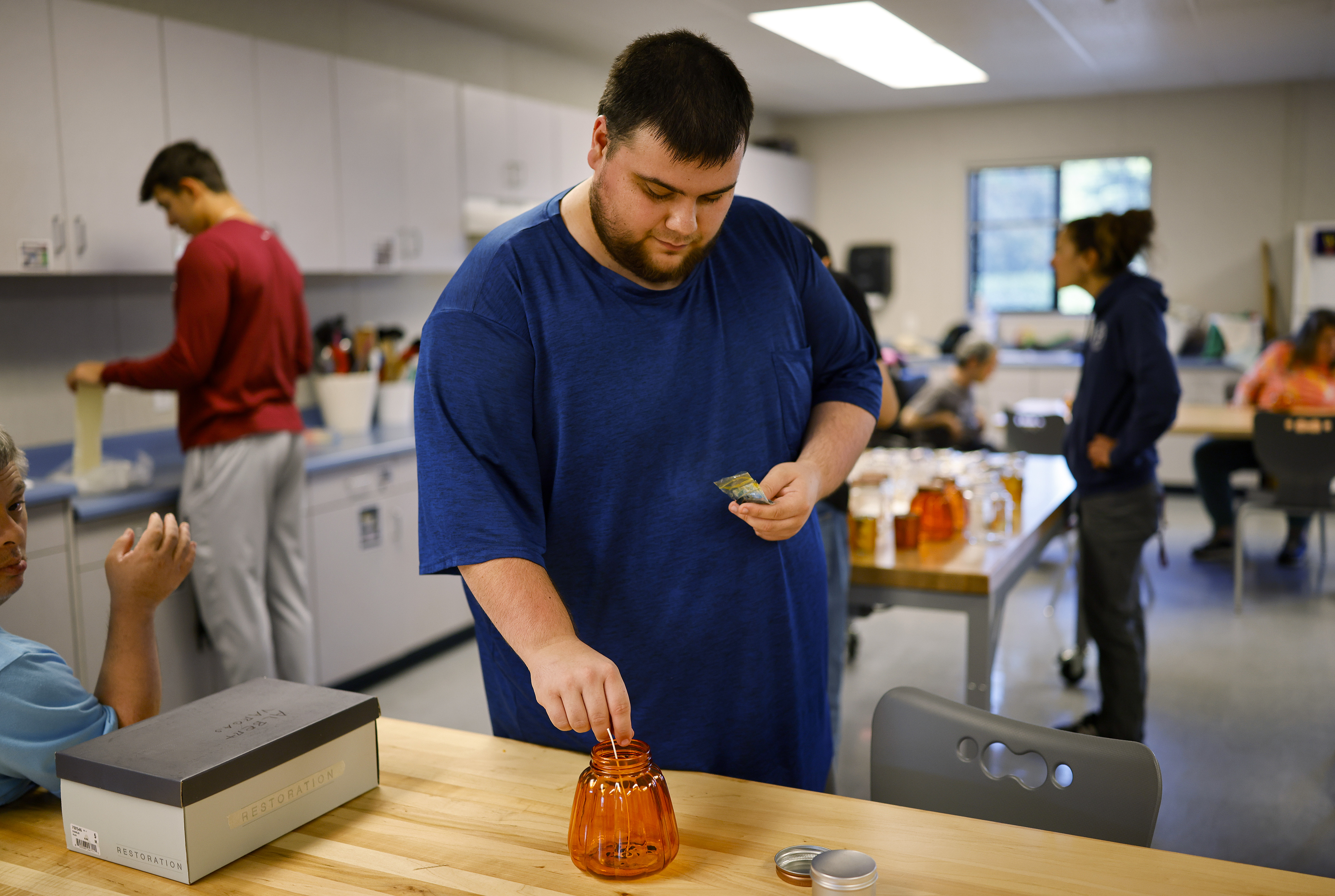 Student Brandon Lopez leads a candle making class at the...