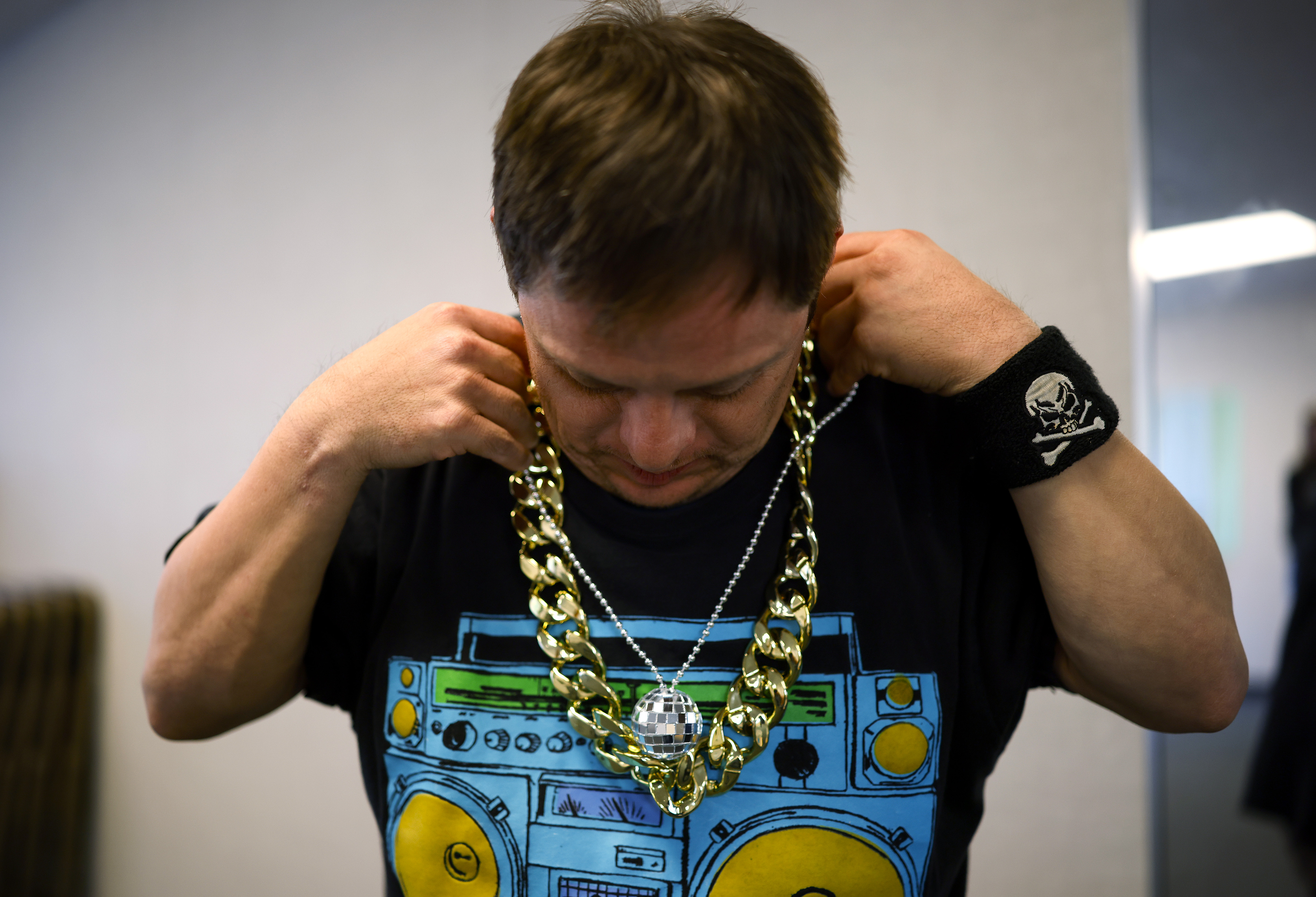 Student Abraham Leza puts on his bling before leadting the...