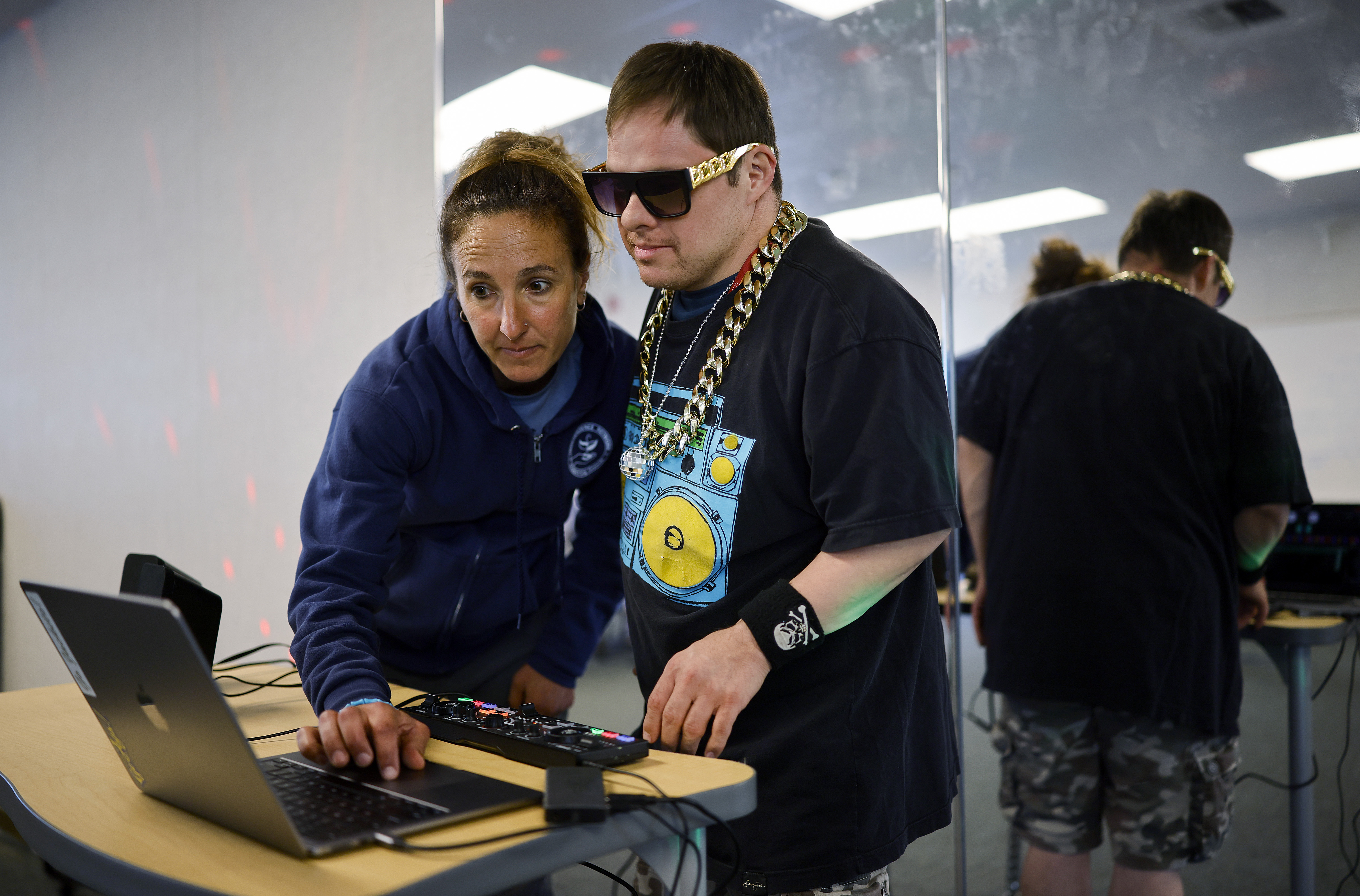 Mireya SÃ¡nchez, left, Independence Network program coordinator, helps Abraham Leza...