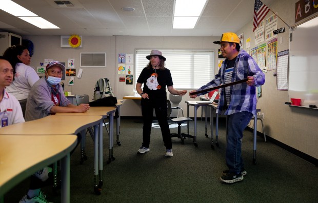 Student Cacho Reyes, right, dances as he leads a workout/Spanish class called "Amigos Workout" as Mindy Burger, center, dances along at the Independence Network in Santa Clara, Calif., on Friday, Oct. 10, 2025. Wish Book for the Independence Network. (Nhat V. Meyer/Bay Area News Group)