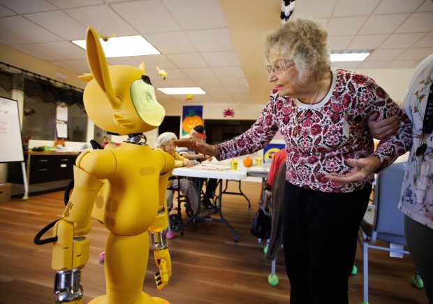 Client Marieta Chapman, right, talks to "Miroki," a social companion robot brought in to interact with clients at Live Oak Adult Day Services in San Jose, Calif., on Nov. 4, 2025. (Dai Sugano/Bay Area News Group)