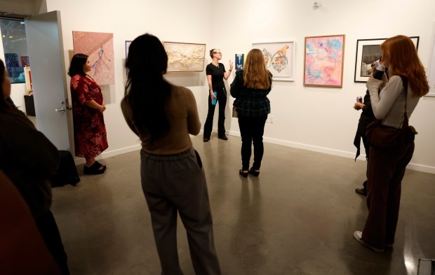 Artist Janet Appleton talks about her artwork titled "Spinal Lily," a cyanotype mounted on wood, during an artists talk at the Noble Workshop & Gallery in downtown San Jose, Calif., on Thursday, Oct. 16, 2025. Wish Book for Local Color. (Nhat V. Meyer/Bay Area News Group)