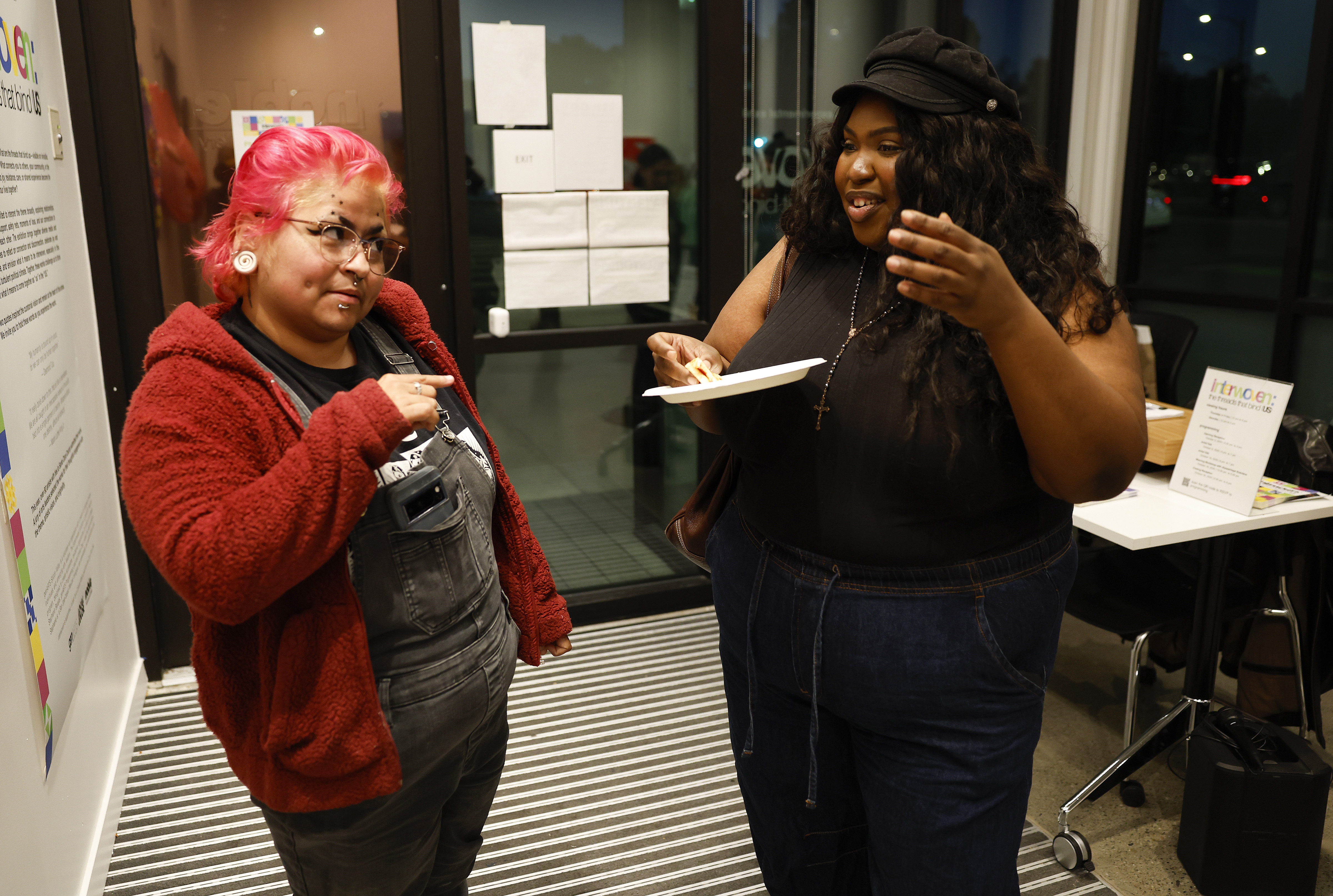 Artist Cynthia Yadira Gonzalez, left, chats with artist Tachiya Bryant...