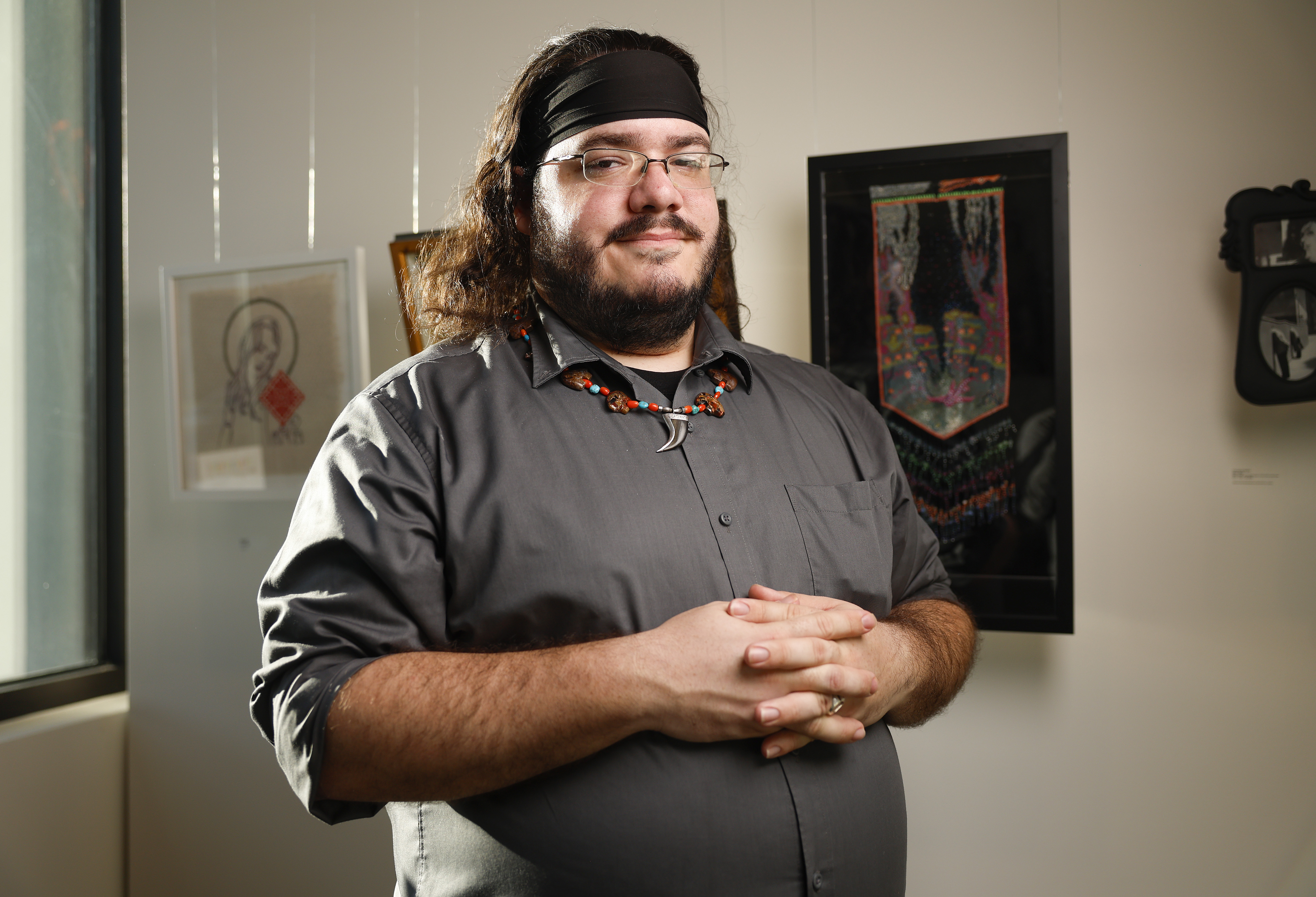 Artist John Paul Amaral poses next to his artwork titled...