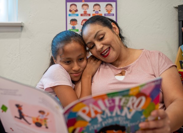 Alba Vivas, of San Jose, reads a book to her daughter Ariana, 9, at their home in San Jose, Calif., on Thursday, Sept. 25, 2025. Vivas is one of the parents with a child with disabilities who receives help from the nonprofit Parents Helping Parents. (Doug Duran/Bay Area News Group)