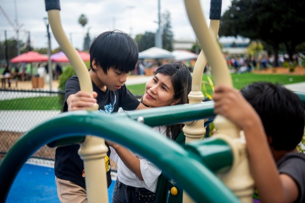Thu Buu Vien, of San Jose, plays with her son Hien, 9, at Fair Oaks Park's Magical Bridge Playground in Sunnyvale, Calif., on Sunday, Sept. 28, 2025. Vien is one of the parents with a child with disabilities who receives help from the nonprofit Parents Helping Parents. (Doug Duran/Bay Area News Group)