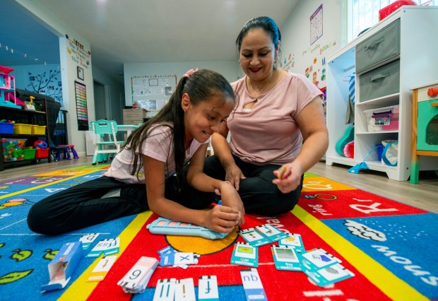 Alba Vivas, of San Jose, helps her daughter Ariana, 9, with a phonics flash card game at their home in San Jose, Calif., on Thursday, Sept. 25, 2025. Vivas is one of the parents with a child with disabilities who receives help from the nonprofit Parents Helping Parents. (Doug Duran/Bay Area News Group)