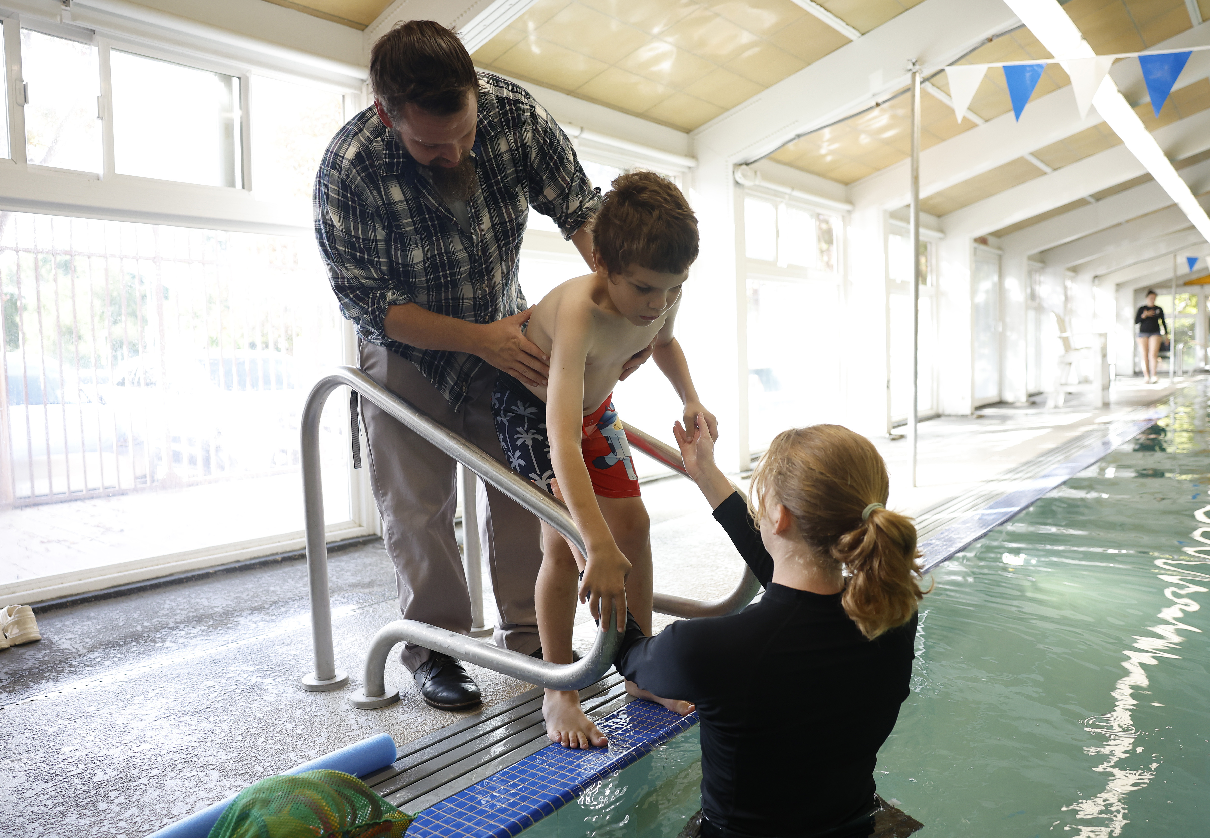 Jason Foreman, from San Jose, helps his son Lucas, 9,...