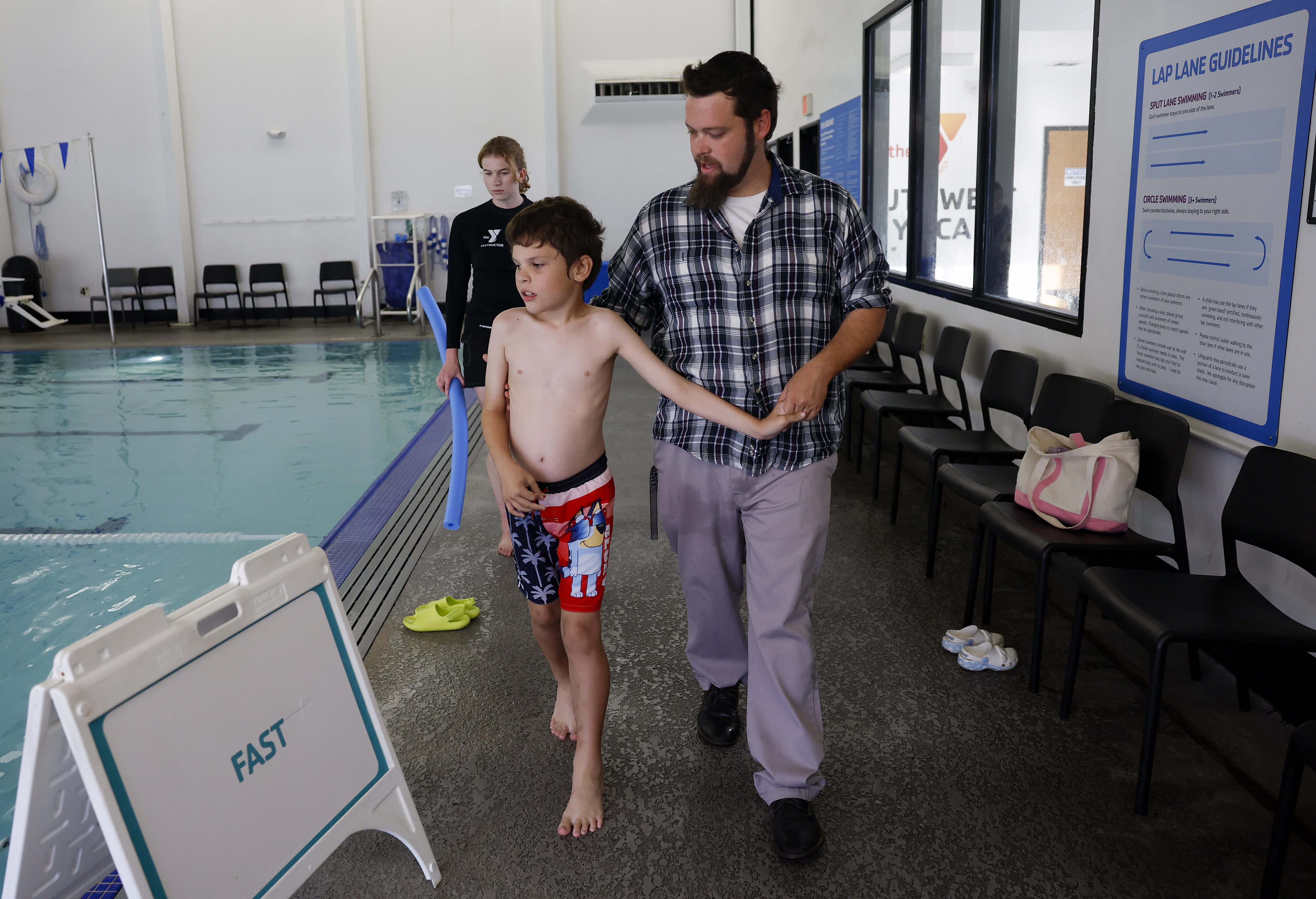 Jason Foreman, from San Jose, walks with son Lucas, 9,...