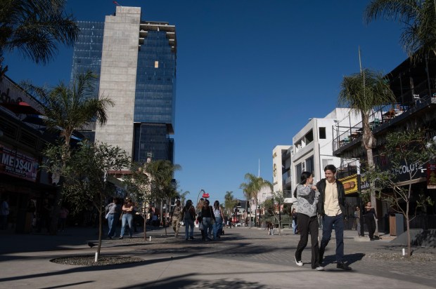People walk along Tijuana's Avenida Revolucion.(David Maung / For The San Diego Union-Tribune)