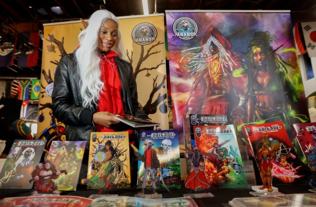 Enaya Thomas at the anasi Comics booth at Black Comix Day 2025 at the World Beat Center in Balboa Park on Saturday, Feb. 15, 2025 in San Diego. The festival celebrates Black excellence and features Black comic artists, food and activities for kids.. (Sandy Huffaker / For The San Diego Union-Tribune)