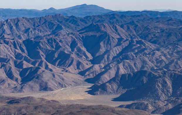 The flat area of Sheep Canyon where the search base was located and the mountains where Lou Shrinkle was stranded by deep snow. Had he not been rescued, he would have had this terrain to navigate with frostbitten toes. (Ernie Cowan / For The San Diego Union-Tribune)