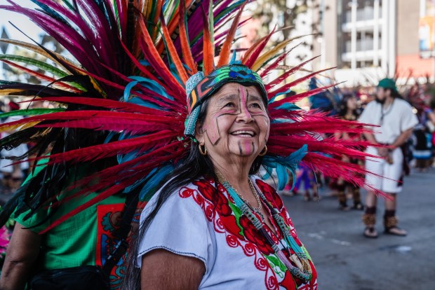An Aztec dancer during Chicano Park Day in Barrio Logan on April 19, 2025. (Ariana Drehsler / For The San Diego Union-Tribune)