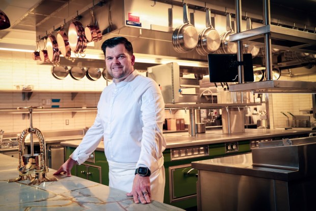 Chef-owner Travis Swikard stands in the kitchen area of his new French restaurant Fleurette in the UTC area of San Diego. It opened Dec. 10. (Sandy Huffaker for The San Diego Union-Tribune)
