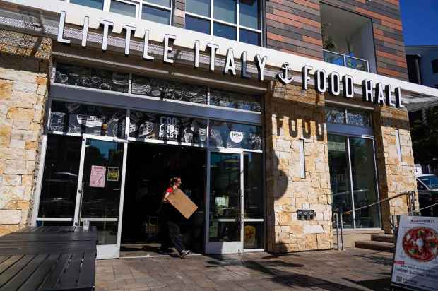 The Little Italy Food Hall, closed its doors on Feb. 16, 2025. Makayla Martin taking a box out of the public market in Little Italy on Monday, Feb. 17, 2025 in San Diego, California.