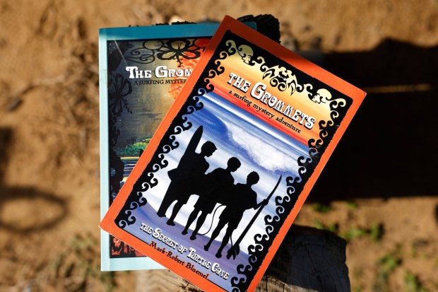 Mark-Robert Bluemel, a lawyer and a surfer, has written a series of young adult books based on a trio of kids he calls the Grommets, shown here on Dec. 21, 2025, in San Diego. Bluemel, who copyrighted his creation in 2008, is involved in a legal battle with another publisher using the same name. (K.C. Alfred / The San Diego Union-Tribune)