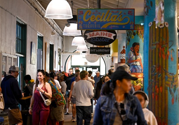 People walk inside of the Liberty Public Market Nov. 9, 2025 in San Diego, Calif. (Photo by Denis Poroy)
