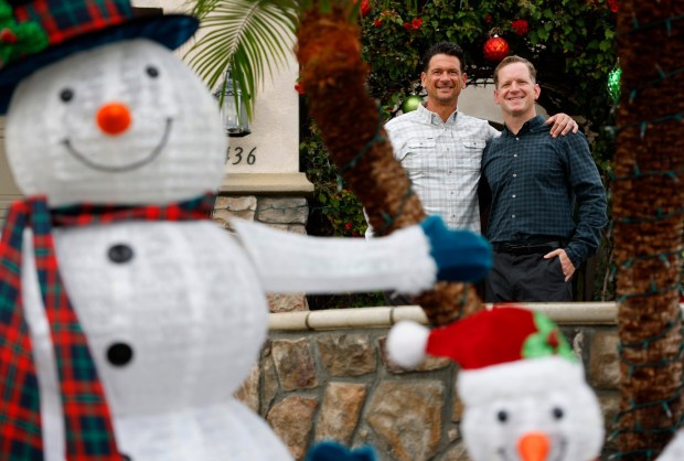 Carlsbad, CA - December 3: Dr. Andrew Eads, right, helped save the life of his neighbor John Griffith who had a cardiac arrest in October, shown here on December 24, 2025 in Carlsbad, CA. (K.C. Alfred / The San Diego Union-Tribune)