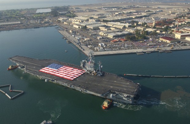 The US Navy aircraft carrier USS Nimitz is nursed to its' berth with tugboats at North Island Naval Air Station after an eight month deployment to the conflict in Iraq Wednesday, Nov. 5, 2003. The carrier was the last to arrive there and the last to return home. The nuclear-powered aircraft carrier led a strike group that included the USS Princeton guided missile cruiser and the USS Bridge combat support ship. It joined five other carrier battle groups in the Persian Gulf to form an unprecedented floating air force within striking distance of Iraq. (AP Photo/San Diego Union-Triibune Photo, John Gibbins)