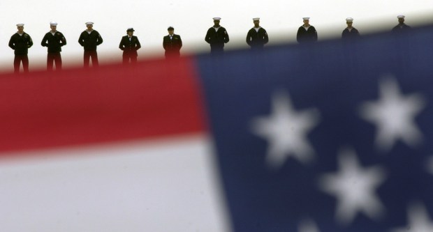 ORG XMIT: CADIU103 Sailors line the aircraft carrier USS Nimitz on Monday, March 3, 2003, as it leaves from Coronado, Calif., on a mission that will bring the aircraft carrier within striking distance of Iraq. (AP Photo/San Diego Union-Tribune, K.C. Alfred)