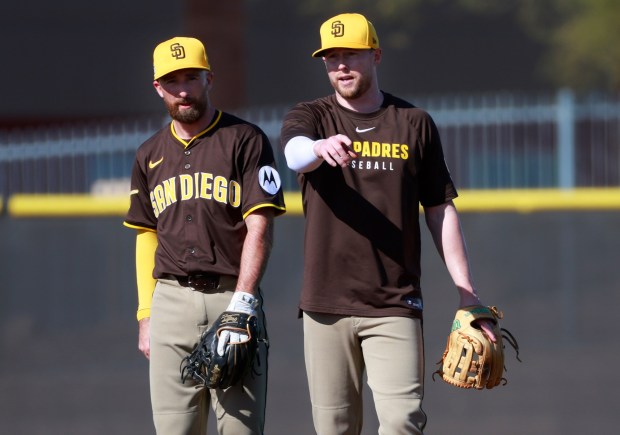 San Diego Padres' Mason McCoy and Jake Cronenworth do drills at second base during a spring training practice on Wednesday, Feb. 19, 2025. (K.C. Alfred / The San Diego Union-Tribune)