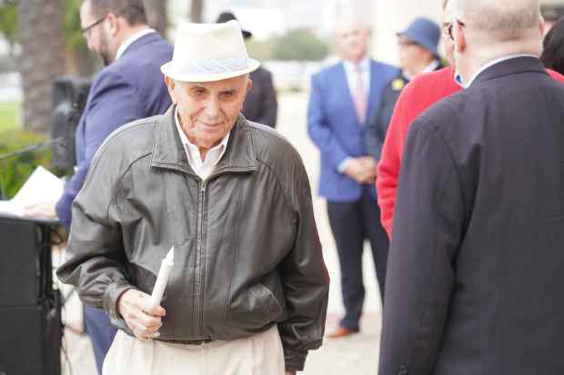 Ben Midler, holds a candle after he lights up the Menorah during the Rally for Light, a Hanukkah Celebration of Unity and Resilience at the County of San Diego Administration Center on Monday, Dec. 22, 2025 in San Diego, CA. (Michael Ho / For The San Diego Union-Tribune)