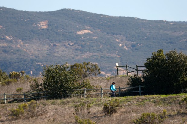 San Diego, CA - November 30: A hiker walks on Fortuna Saddle Trail on the west side of Mission Trails Regional Park on November 30, 2025 in San Diego, CA. (K.C. Alfred / The San Diego Union-Tribune)