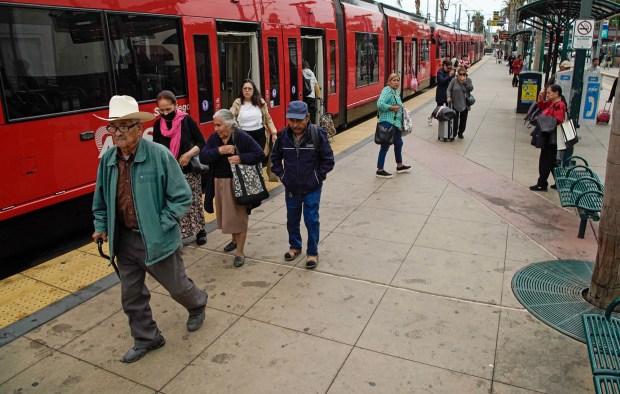 A group of riders walking out of a trolley along the San Ysidro Transit Center in San Ysidro on Thursday, Oct. 17, 2024, in San Diego. (Alejandro Tamayo / The San Diego Union-Tribune)