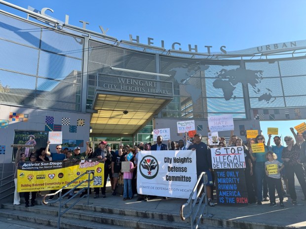 Community members and advocates gather in front of the City Heights Library on Dec. 7 in solidarity with the Somali community. (Alexandra Mendoza / The San Diego Union-Tribune)