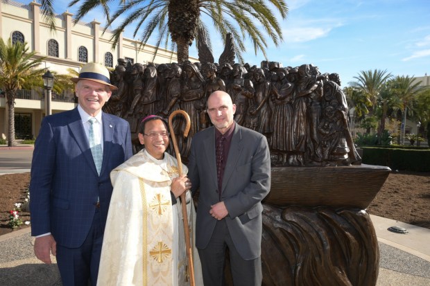 James T. Harris III, president of the University of San Diego, with San Diego bishop Michael Pham and artist Timothy Schmalz, who designed and created "Angels Unawares," a copper sculpture on the grounds of the USD campus. (University of San Diego)