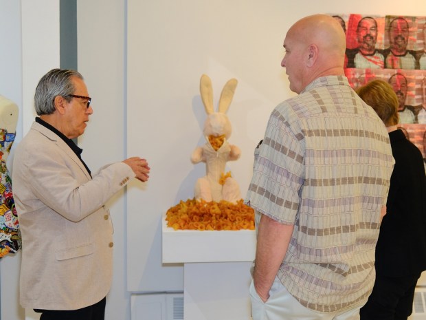 Visions Museum of Textile Art curator Armando Garcia-Orso, left, talks to patrons about "Interpretations 2025." (Steve Colburn)