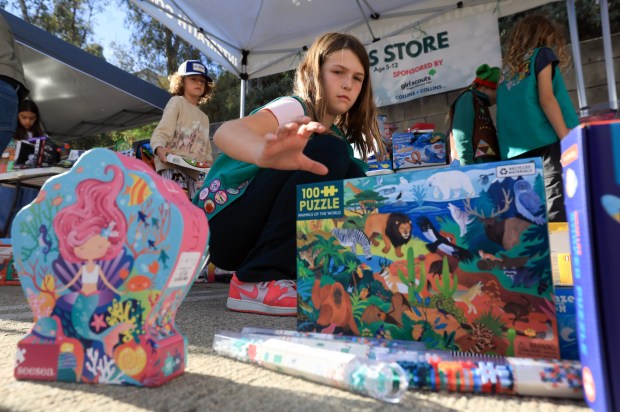 ESCONDIDO, CA - December 13, 2025: Scarlet Swiss, 10, helps organize children's games as she and fellow members of Encinitas Girl Scouts Troop 1015 volunteer during Interfaith Community Services' annual Winterfaith, a two day event where 250 families in need received food, clothing and Christmas gifts, with the help of around 150 volunteers, at Interfaith Community Services in Escondido on Saturday, December 13, 2025. (Hayne Palmour IV / For The San Diego Union-Tribune)