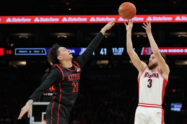 Arizona guard Anthony Dell'Orso (3) shoots over San Diego State guard Miles Byrd during the second half of an NCAA college basketball game, Saturday, Dec. 20, 2025, in Phoenix. (AP Photo/Rick Scuteri)