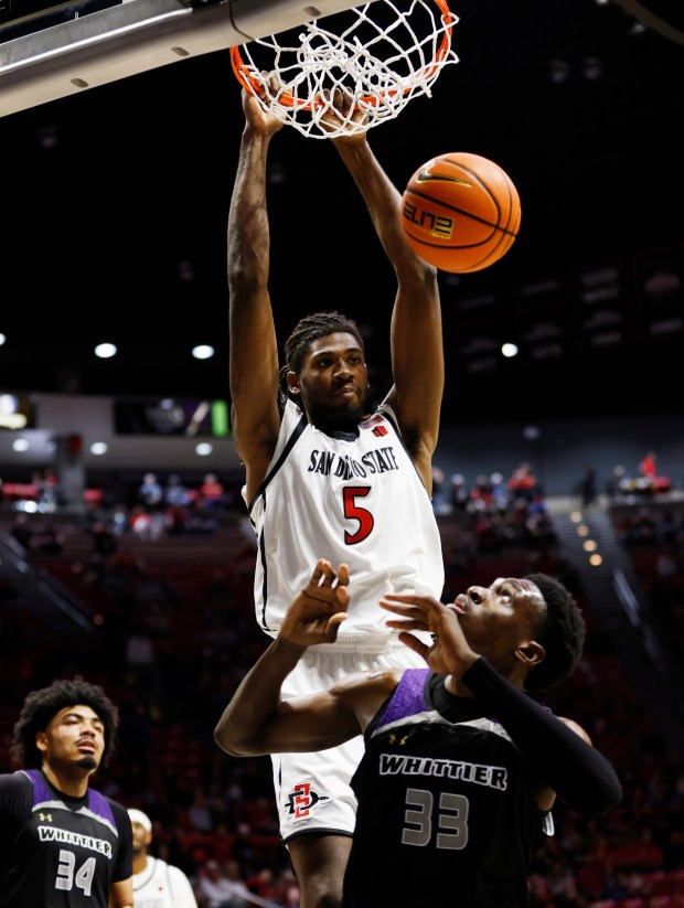 San Diego, CA - December 22: Pharaoh Compton #5 of San Diego State dunks against Tochi Onyeador #33 of Whittier at Viejas Arena on December 22, 2025 in San Diego, CA. (K.C. Alfred / The San Diego Union-Tribune)