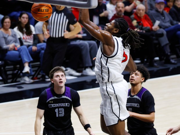 SDSU's Pharaoh Compton scores over two Whittier players in the 121-59 win at Viejas Arena on Monday. (K.C. Alfred / The San Diego Union-Tribune)