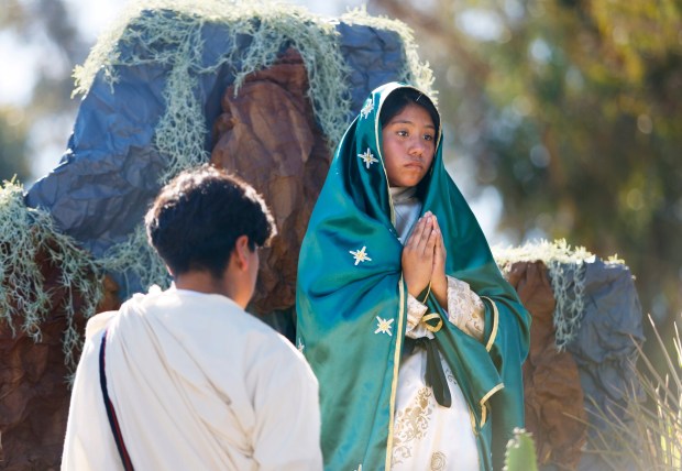 San Diego, CA - December 7: Samuel Gonzalez and Jocelyn Lucas from St. Mary Catholic Church in Escondido participate in a procession to honor Our Lady of Guadalupe near Morley Field on December 7, 2025 in San Diego, CA. The annual procession through North Park streets featured floats, Aztec dancers, musicians and dozens of parish groups followed by a mass at St. Augustine High School. (K.C. Alfred / The San Diego Union-Tribune)