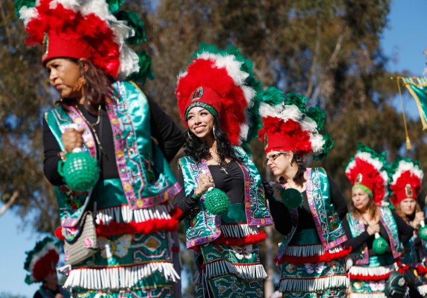 San Diego, CA - December 7: Estela Bustillos and other dancers from Our Lady of Guadalupe Church in Chula Vista perform during a procession to honor Our Lady of Guadalupe near Morley Field on December 7, 2025 in San Diego, CA. The annual procession through North Park streets featured floats, Aztec dancers, musicians and dozens of parish groups followed by a mass at St. Augustine High School.  (K.C. Alfred / The San Diego Union-Tribune)