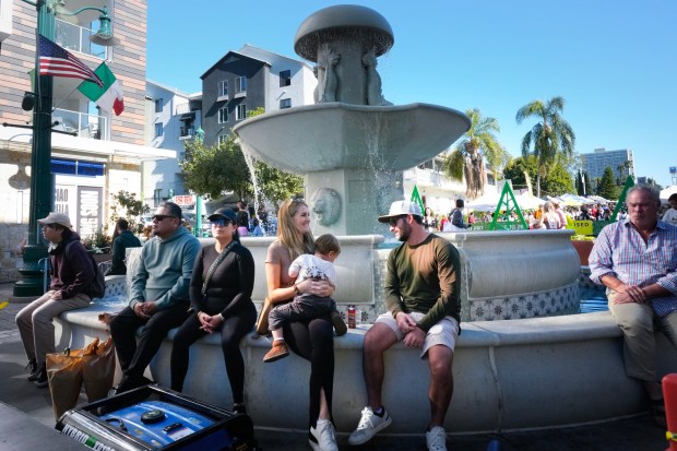 People took time to rest at the Little Italy Fountain on Date Street as they enjoyed the afternoon in Little Italy on Saturday, Dec. 6, 2025, in San Diego, CA.  (Nelvin C. Cepeda / The San Diego Union-Tribune)